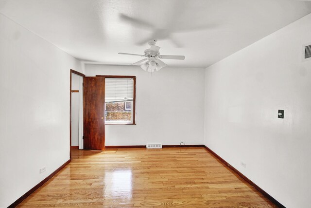 14528 Grant St, Dolton, IL 60419 - empty room featuring a ceiling fan and light wood finished floors