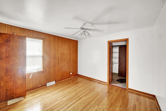 14528 Grant St, Dolton, IL 60419 - empty room with wood finished floors, ceiling fan, wooden walls, and ornamental molding