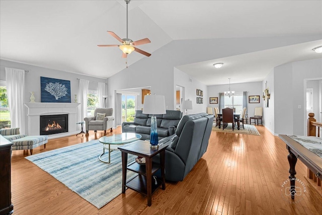 0N585 Charlotte Dr, Geneva, IL 60134 - living area featuring ceiling fan, lofted ceiling, light wood-type flooring, a glass covered fireplace, and plenty of natural light