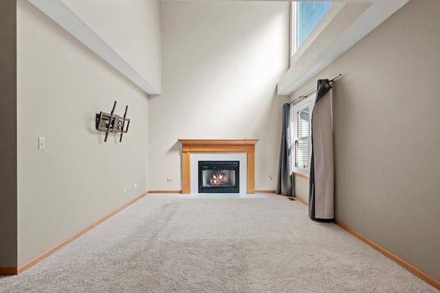 179 Briarcliff Ct, Romeoville, IL 60446 - unfurnished living room with carpet, a towering ceiling, and a tiled fireplace