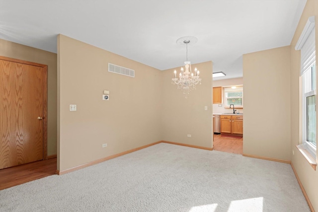 179 Briarcliff Ct, Romeoville, IL 60446 - unfurnished room with light colored carpet and a chandelier