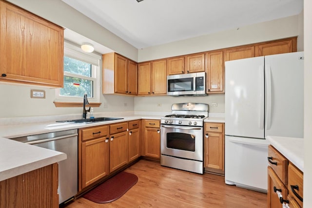 179 Briarcliff Ct, Romeoville, IL 60446 - kitchen with stainless steel appliances, light countertops, light wood-type flooring, and brown cabinets