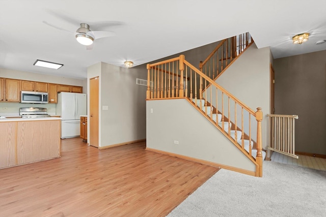 179 Briarcliff Ct, Romeoville, IL 60446 - unfurnished living room with light wood finished floors, ceiling fan, and stairs