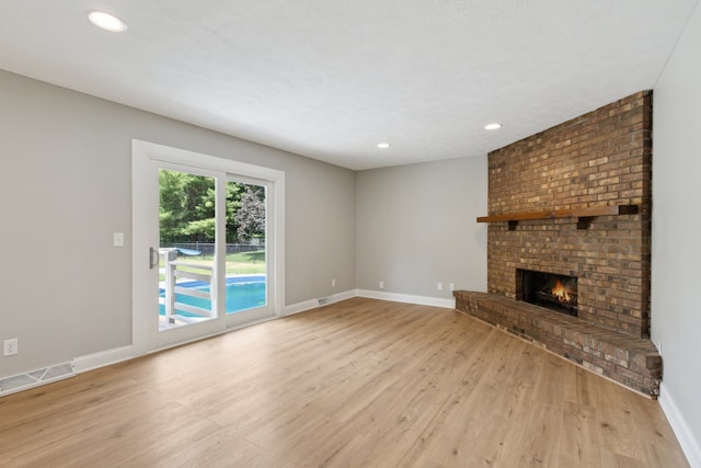6282 Schaumburg Ln, Roscoe, IL 61073 - unfurnished living room featuring wood finished floors, a fireplace, and recessed lighting