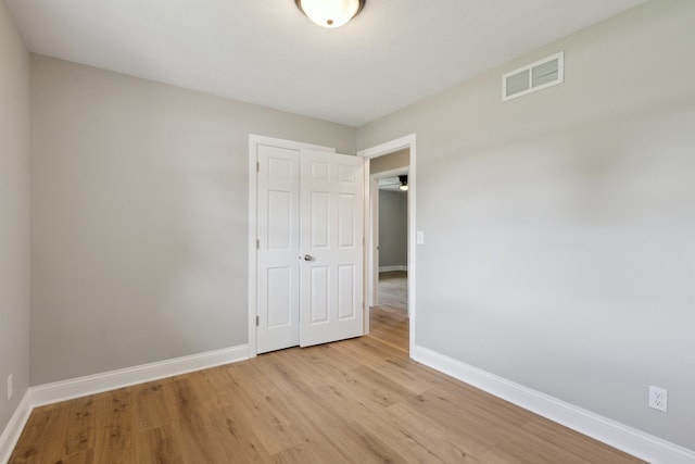 6282 Schaumburg Ln, Roscoe, IL 61073 - unfurnished bedroom featuring a closet and light wood-style flooring