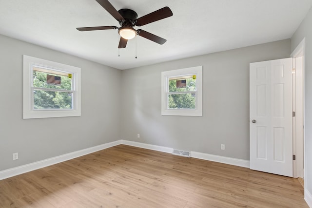 6282 Schaumburg Ln, Roscoe, IL 61073 - empty room with healthy amount of natural light, light wood-style flooring, and a ceiling fan