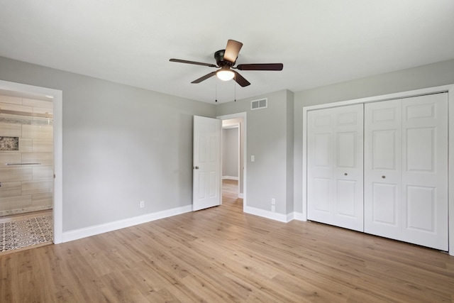 6282 Schaumburg Ln, Roscoe, IL 61073 - unfurnished bedroom featuring light wood-style flooring, a closet, connected bathroom, and a ceiling fan
