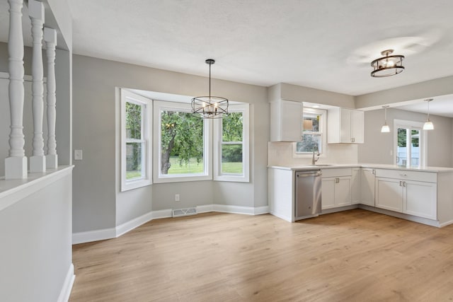6282 Schaumburg Ln, Roscoe, IL 61073 - kitchen featuring stainless steel dishwasher, light wood finished floors, white cabinets, and pendant lighting