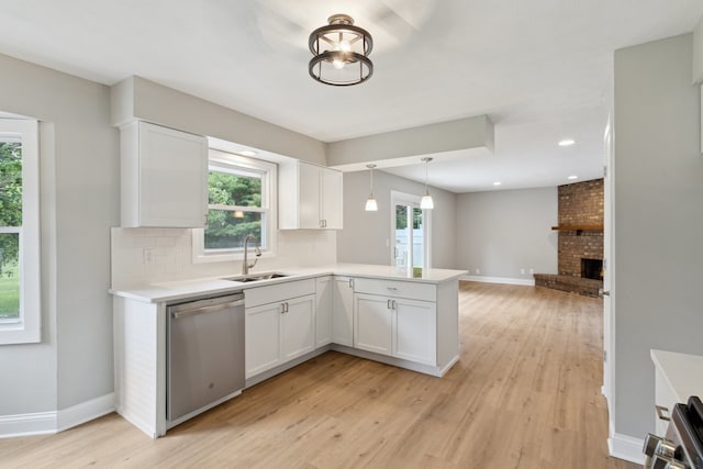 6282 Schaumburg Ln, Roscoe, IL 61073 - kitchen featuring stainless steel dishwasher, a peninsula, light countertops, white cabinetry, and recessed lighting