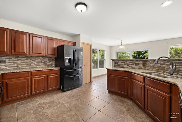 10961 Preston Pkwy, Huntley, IL 60142 - kitchen with black refrigerator with ice dispenser, tasteful backsplash, light stone countertops, tile patterned flooring, and hanging light fixtures