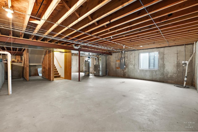 10961 Preston Pkwy, Huntley, IL 60142 - basement featuring water heater, electric panel, stairs, heating unit, and drainage system