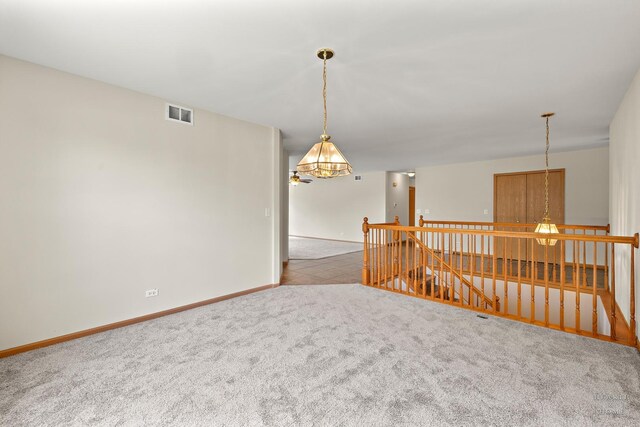 10961 Preston Pkwy, Huntley, IL 60142 - spare room with a chandelier and carpet floors