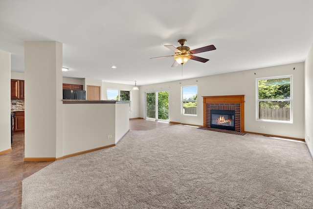 10961 Preston Pkwy, Huntley, IL 60142 - unfurnished living room with plenty of natural light, a ceiling fan, a fireplace, carpet floors, and recessed lighting