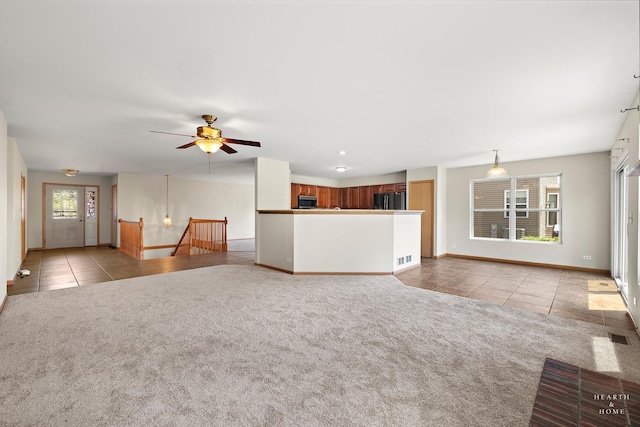 10961 Preston Pkwy, Huntley, IL 60142 - unfurnished living room featuring light tile patterned flooring, plenty of natural light, and light carpet