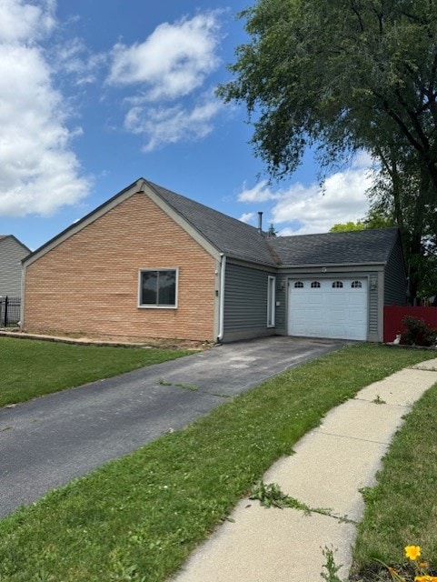 5 Denham Dr, Montgomery, IL 60538 - view of front of home featuring driveway, brick siding, and a garage