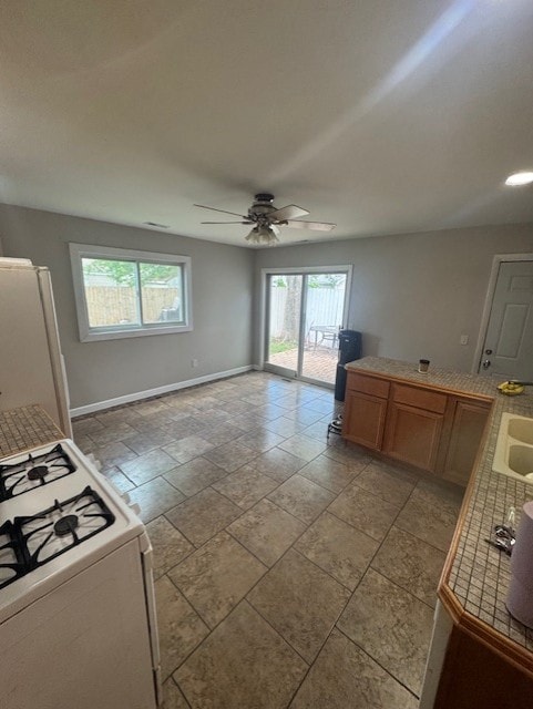 5 Denham Dr, Montgomery, IL 60538 - kitchen featuring white appliances, ceiling fan, brown cabinetry, and tile countertops