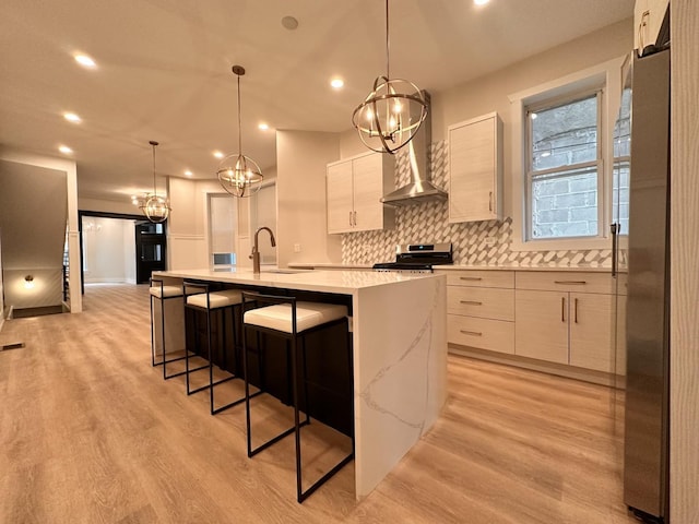 4409 S Prairie Ave, Chicago, IL 60653 - kitchen featuring wall chimney range hood, range with electric cooktop, modern cabinets, light wood finished floors, and recessed lighting