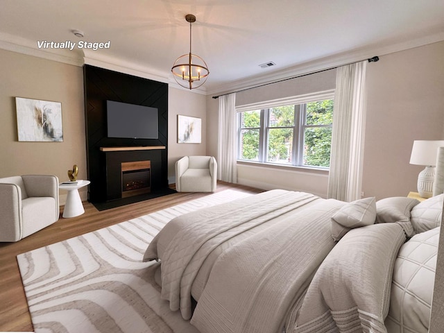 4409 S Prairie Ave, Chicago, IL 60653 - bedroom with wood finished floors, a chandelier, crown molding, and a fireplace