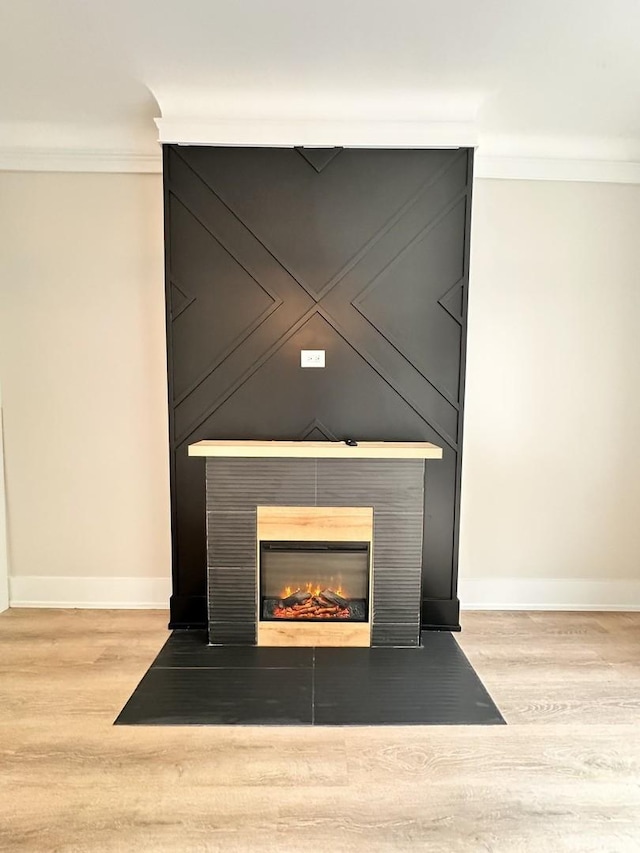 4409 S Prairie Ave, Chicago, IL 60653 - detailed view of wood finished floors, crown molding, and a fireplace