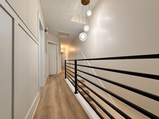 4409 S Prairie Ave, Chicago, IL 60653 - hallway with attic access, light wood-type flooring, and an upstairs landing