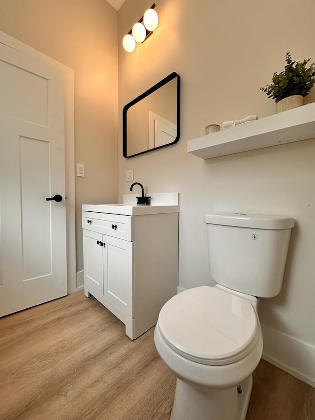 4409 S Prairie Ave, Chicago, IL 60653 - half bathroom featuring wood finished floors and vanity
