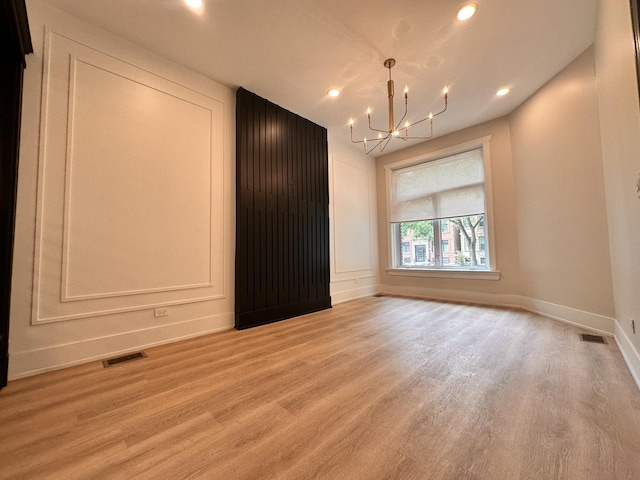 4409 S Prairie Ave, Chicago, IL 60653 - unfurnished room featuring a chandelier, light wood-type flooring, and recessed lighting