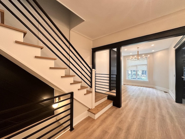 4409 S Prairie Ave, Chicago, IL 60653 - stairs with a chandelier, wood finished floors, and recessed lighting