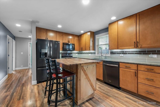 206 N Broadview Ave, Lombard, IL 60148 - kitchen with black appliances, wooden counters, wood finished floors, decorative backsplash, and a breakfast bar