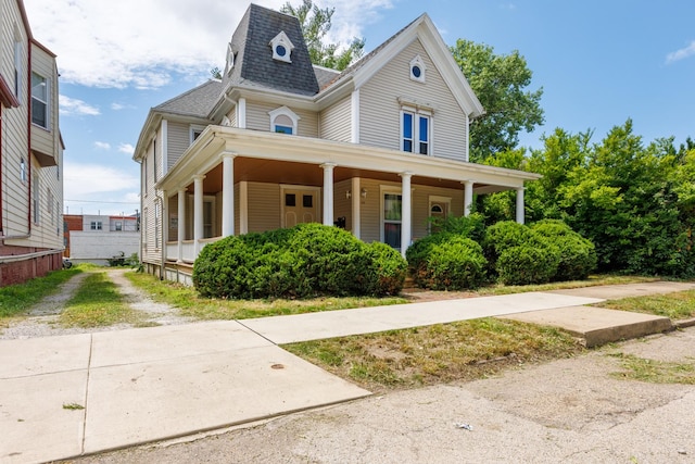211 E Mulberry St, Bloomington, IL 61701 - victorian house featuring a shingled roof and a porch