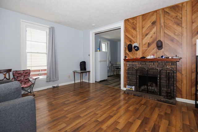 211 E Mulberry St, Bloomington, IL 61701 - living area featuring wood finished floors, a textured ceiling, and a fireplace