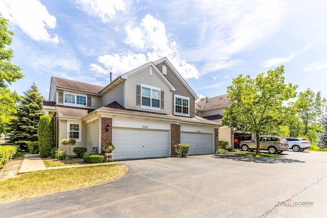 32374 N Allegheny Way Unit 0, Lakemoor, IL 60051 - view of front facade featuring an attached garage, asphalt driveway, and brick siding