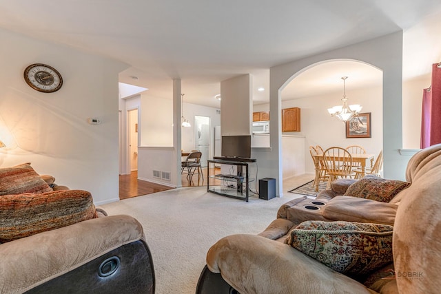 32374 N Allegheny Way Unit 0, Lakemoor, IL 60051 - living area with light colored carpet, arched walkways, and a chandelier