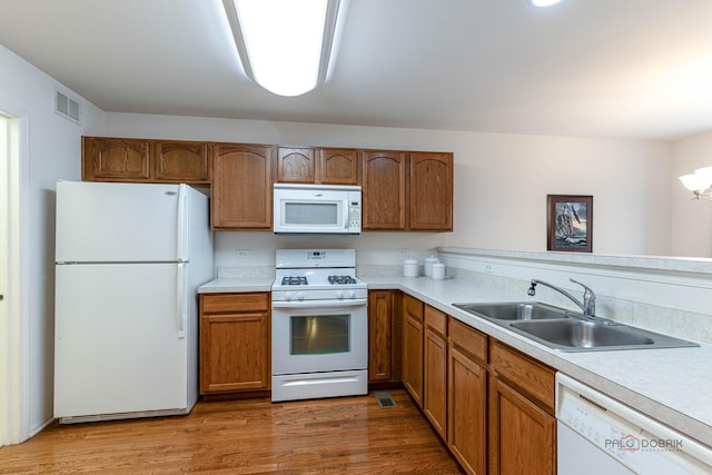32374 N Allegheny Way Unit 0, Lakemoor, IL 60051 - kitchen with white appliances, light countertops, brown cabinetry, and light wood-style floors
