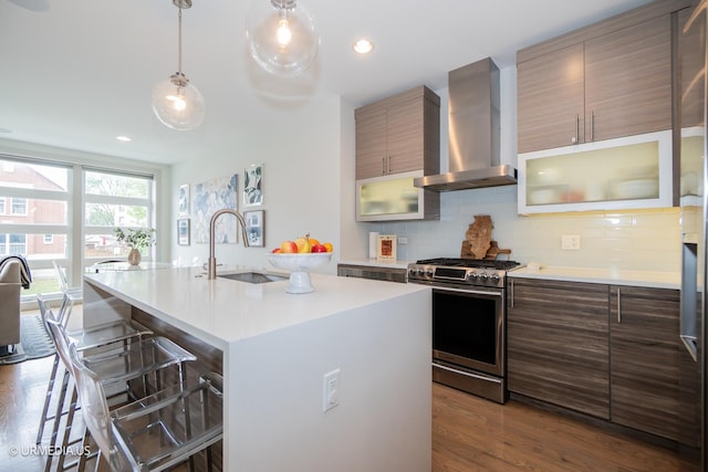 1221 E 46th St Unit 1, Chicago, IL 60653 - kitchen featuring gas stove, wall chimney range hood, a breakfast bar area, light countertops, and recessed lighting