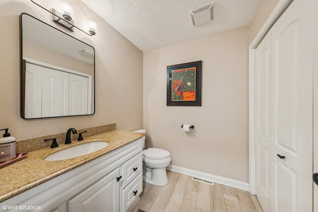 5525 Lee Ave, Downers Grove, IL 60515 - bathroom with vanity, a closet, wood finished floors, and a textured ceiling
