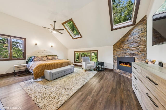 5525 Lee Ave, Downers Grove, IL 60515 - bedroom with dark wood finished floors, a fireplace, a skylight, high vaulted ceiling, and a ceiling fan