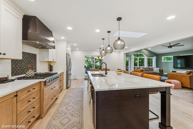 5525 Lee Ave, Downers Grove, IL 60515 - kitchen with wall chimney exhaust hood, appliances with stainless steel finishes, a kitchen bar, recessed lighting, and backsplash