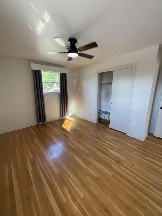 12813 E Playfield Dr, Crestwood, IL 60418 - unfurnished bedroom with light wood-style floors, ceiling fan, and a closet