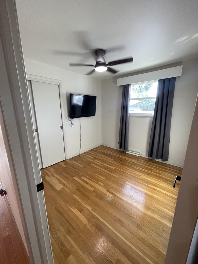 12813 E Playfield Dr, Crestwood, IL 60418 - unfurnished bedroom featuring wood finished floors and a ceiling fan