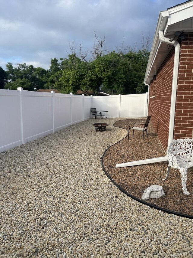 12813 E Playfield Dr, Crestwood, IL 60418 - fenced backyard featuring an outdoor fire pit