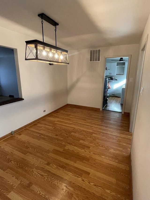 12813 E Playfield Dr, Crestwood, IL 60418 - unfurnished dining area with wood finished floors and baseboards