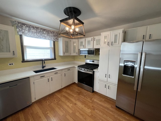 12813 E Playfield Dr, Crestwood, IL 60418 - kitchen featuring appliances with stainless steel finishes, a chandelier, white cabinets, and light countertops
