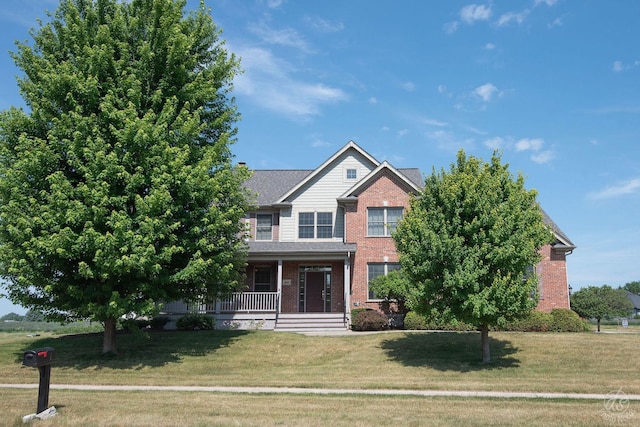 1019 Freedom Cir, Sycamore, IL 60178 - view of front facade with a porch, brick siding, and a front yard