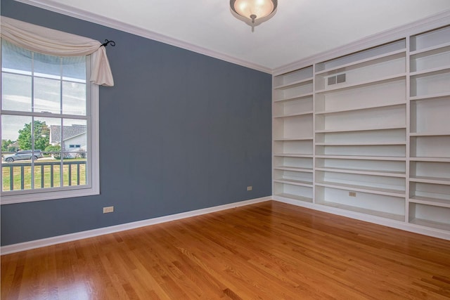 1019 Freedom Cir, Sycamore, IL 60178 - spare room with built in shelves, wood finished floors, and ornamental molding