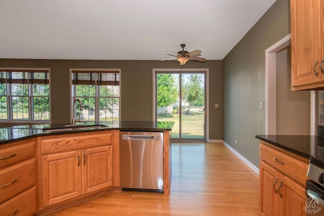 1019 Freedom Cir, Sycamore, IL 60178 - kitchen featuring stainless steel dishwasher, a ceiling fan, light wood-style floors, dark stone countertops, and vaulted ceiling