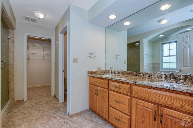 1019 Freedom Cir, Sycamore, IL 60178 - bathroom with a stall shower, double vanity, a walk in closet, and recessed lighting