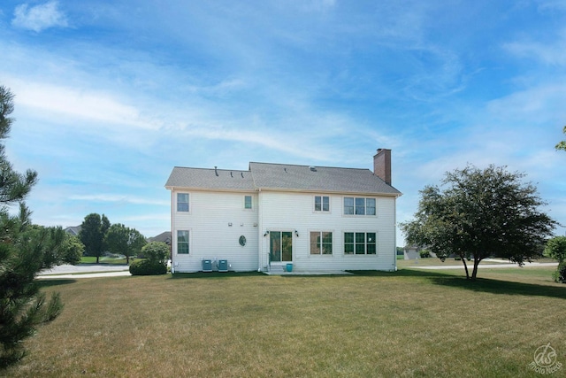 1019 Freedom Cir, Sycamore, IL 60178 - rear view of house with a chimney and a lawn