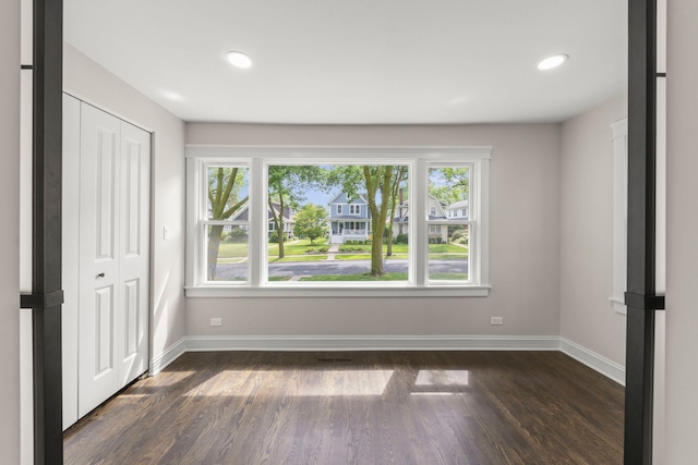 342 Franklin Ave, River Forest, IL 60305 - unfurnished bedroom featuring multiple windows, dark wood-style flooring, recessed lighting, and a closet