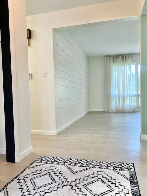 909 N Brinton Ave, Dixon, IL 61021 - hallway featuring wood finished floors and wooden walls
