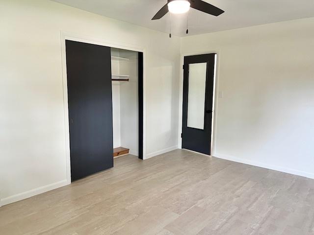 909 N Brinton Ave, Dixon, IL 61021 - unfurnished bedroom featuring light wood-type flooring, a closet, and ceiling fan